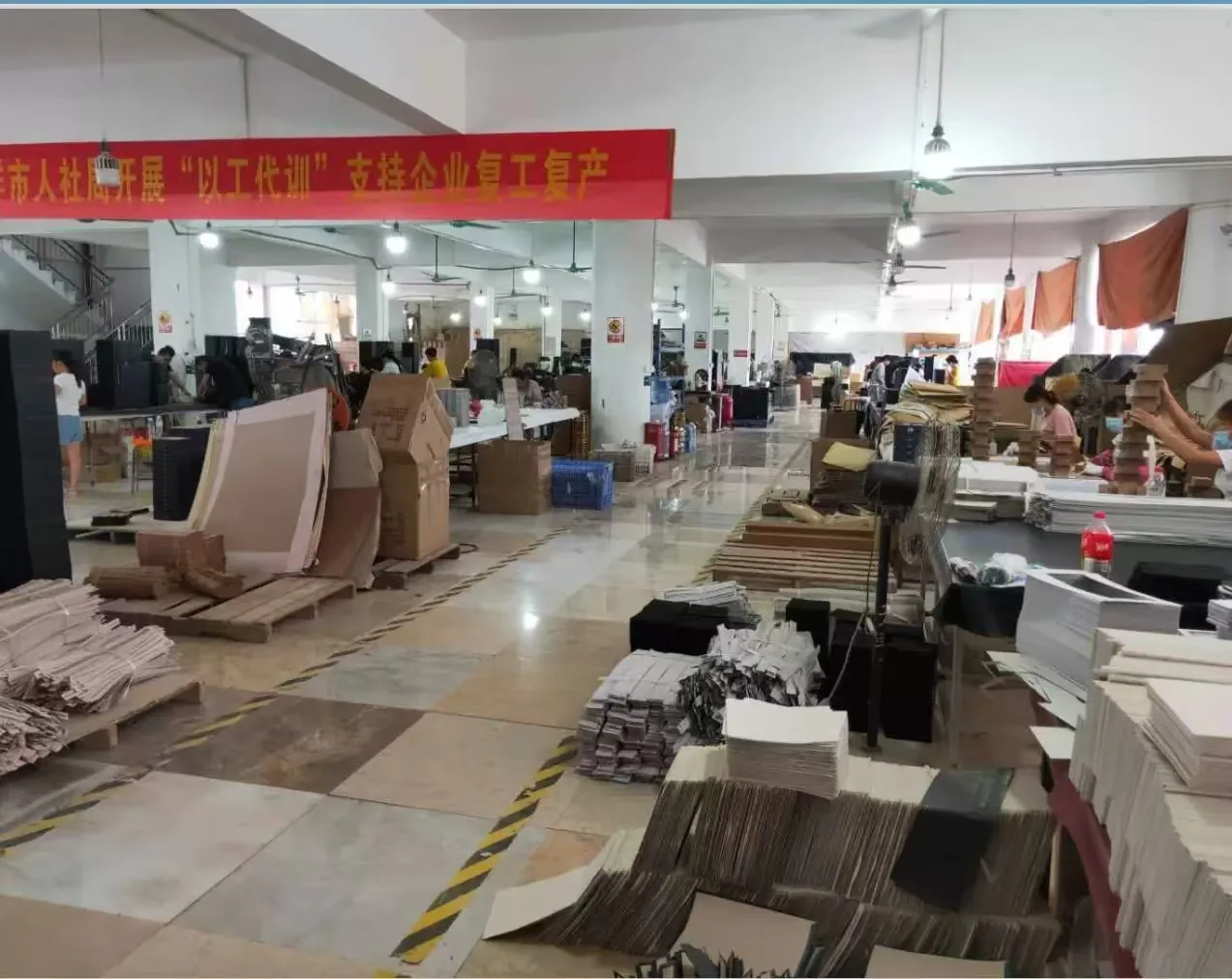 Jewelry packaging workshop with production tables