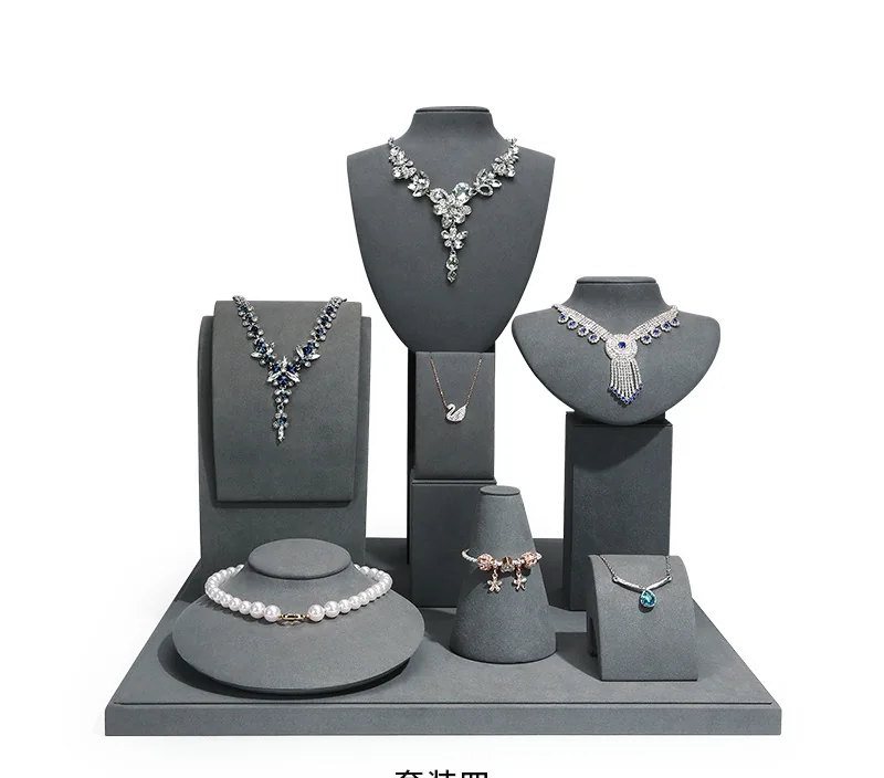 Gray jewelry display stand set with necklace busts and jewelry risers