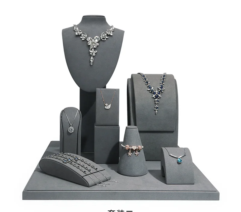 Gray jewelry display stand set with necklace busts and jewelry risers